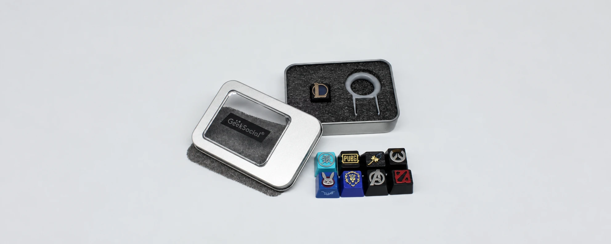 Metal keycap presentation tin with protective insert and keyboard accessories
