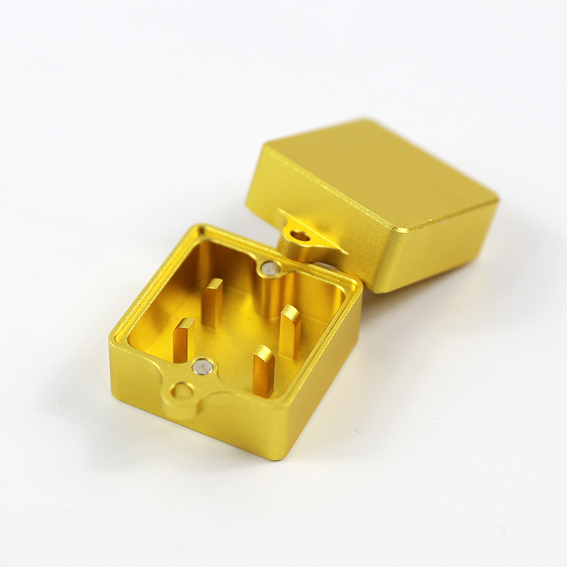 Gold metal keyboard switch opener shown open