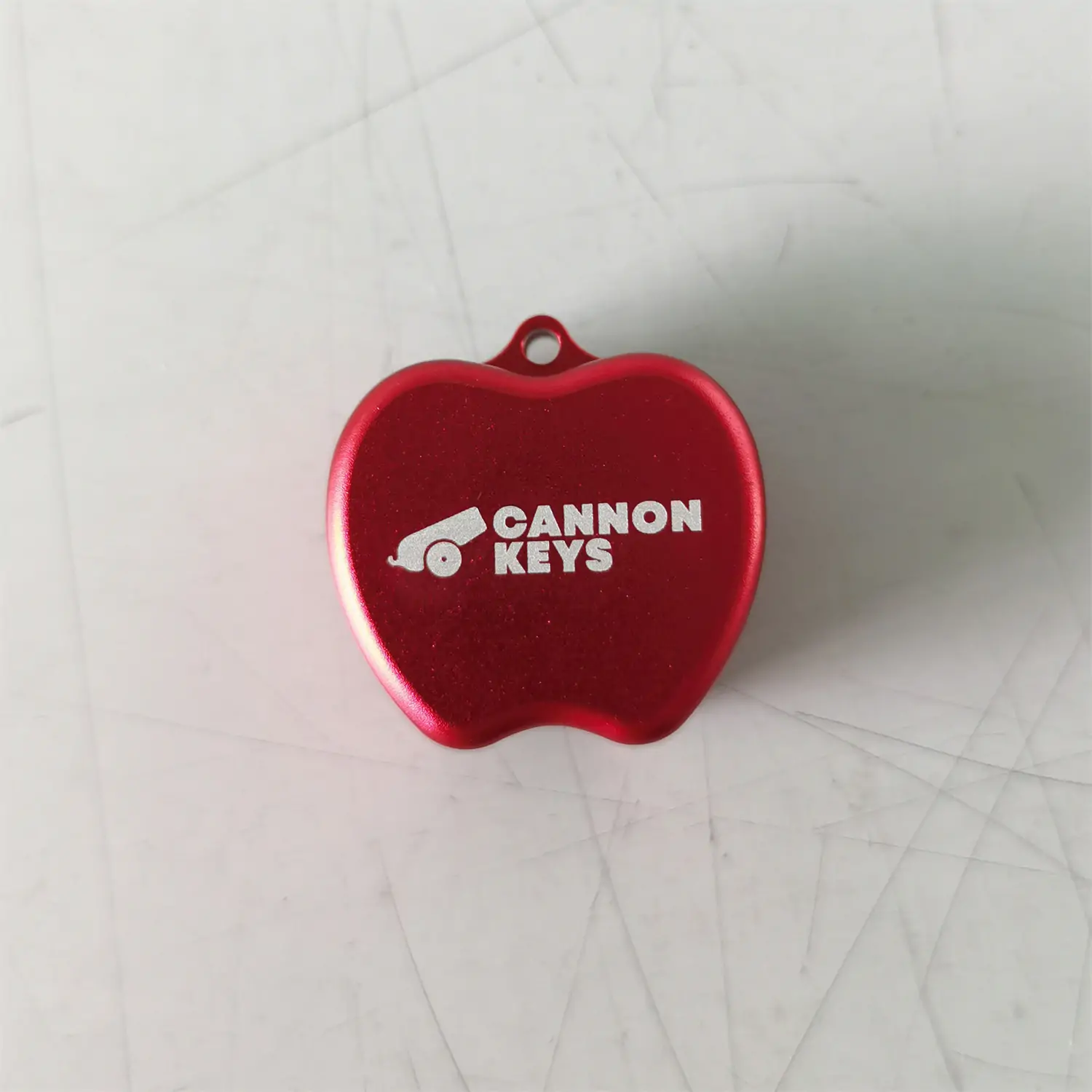 Customer logo laser engraved on a red anodized metal switch opener