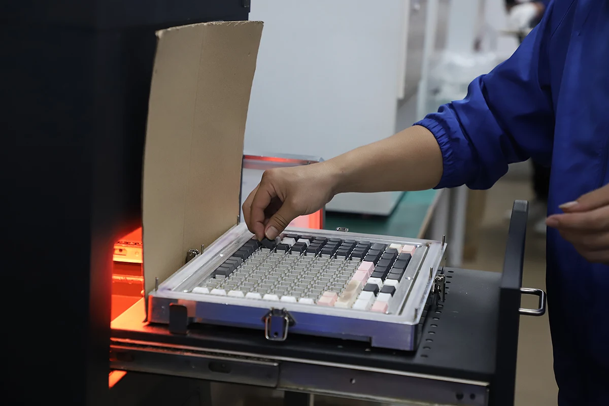 Keycap trays handled at production equipment